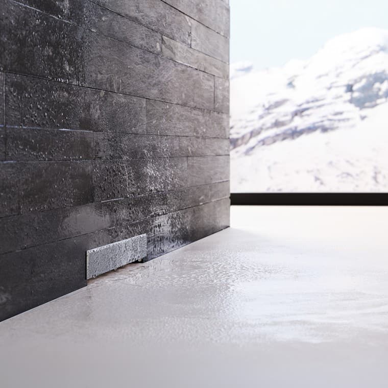 Трапа Geberit у чорній цегляній стіні Трапа Geberit у чорній цегляній стіні